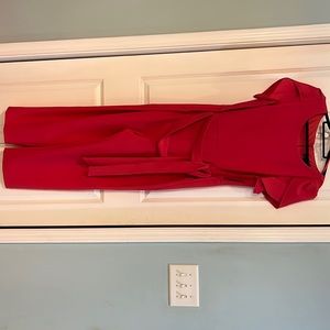 BNWT ladies fushia jumpsuit. Size 14. Has flower cut sleeves and built in belt